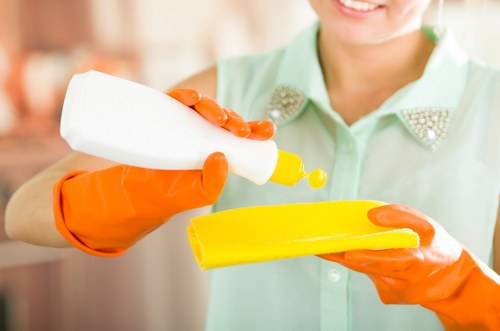 A cleaner working on a kitchen appliance in an E17 property