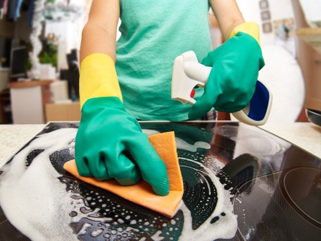 Carpet cleaning technician treating a carpet in a customer property